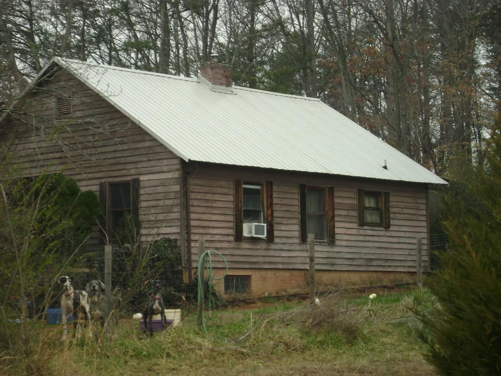 White metal roof on an old wood sided farmhouse, from a Metal Roof Installation job in Meigs